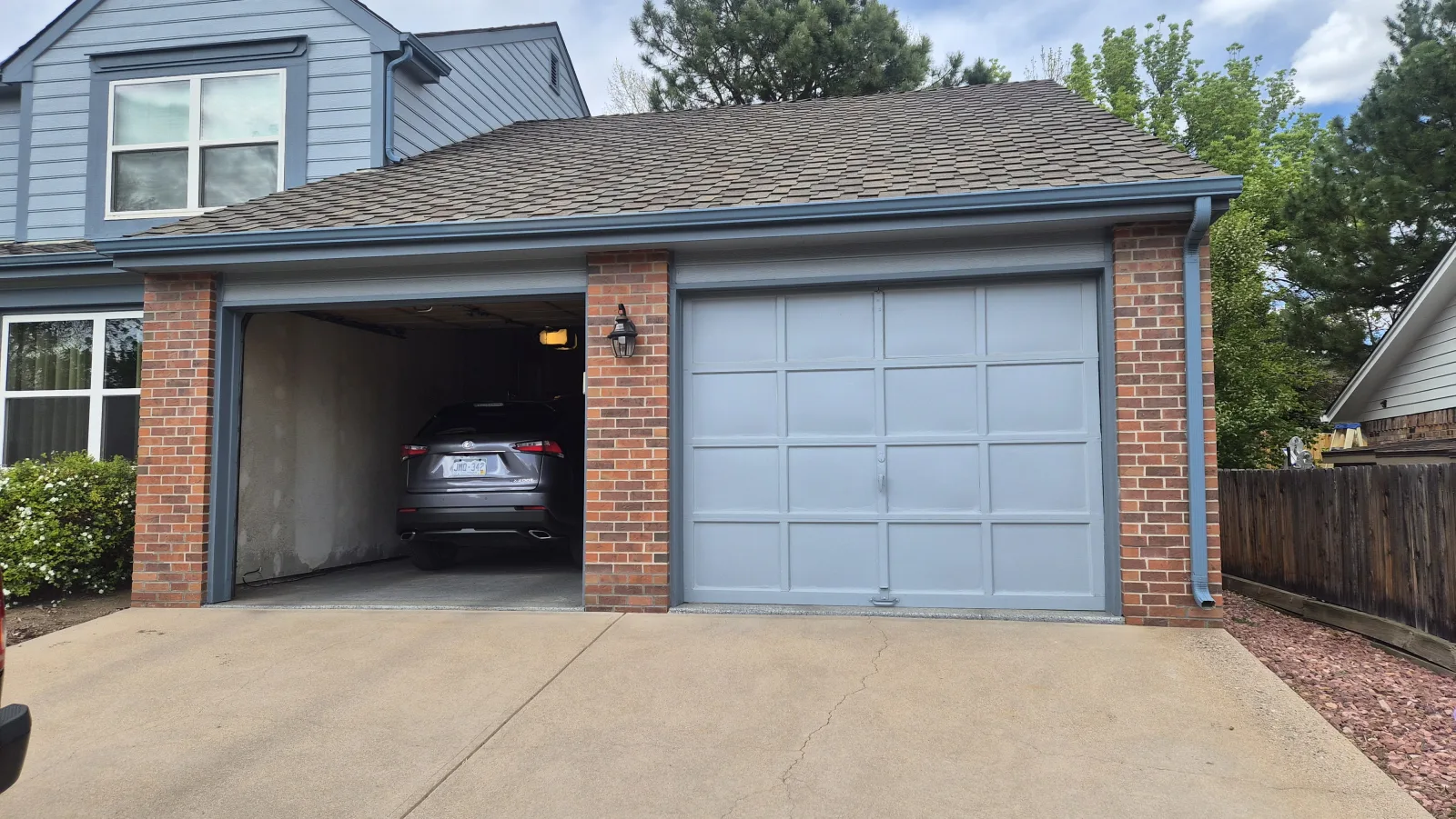 Dark garage door on brick home completed