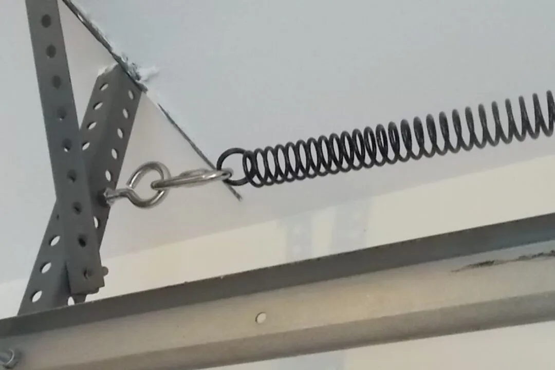 Garage door hardware parts including extension spring components
