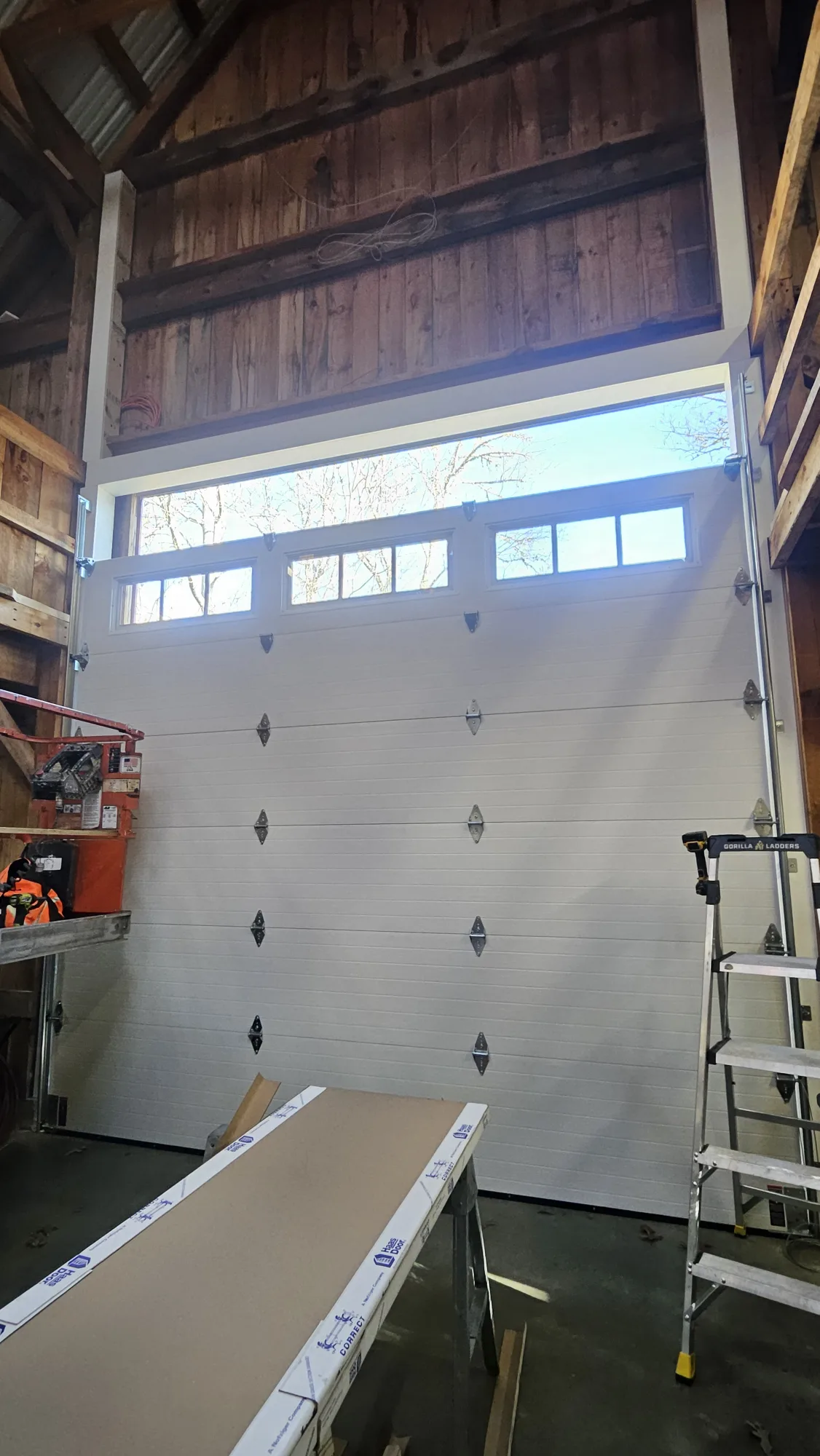 Garage door installation in progress showing insulated layers