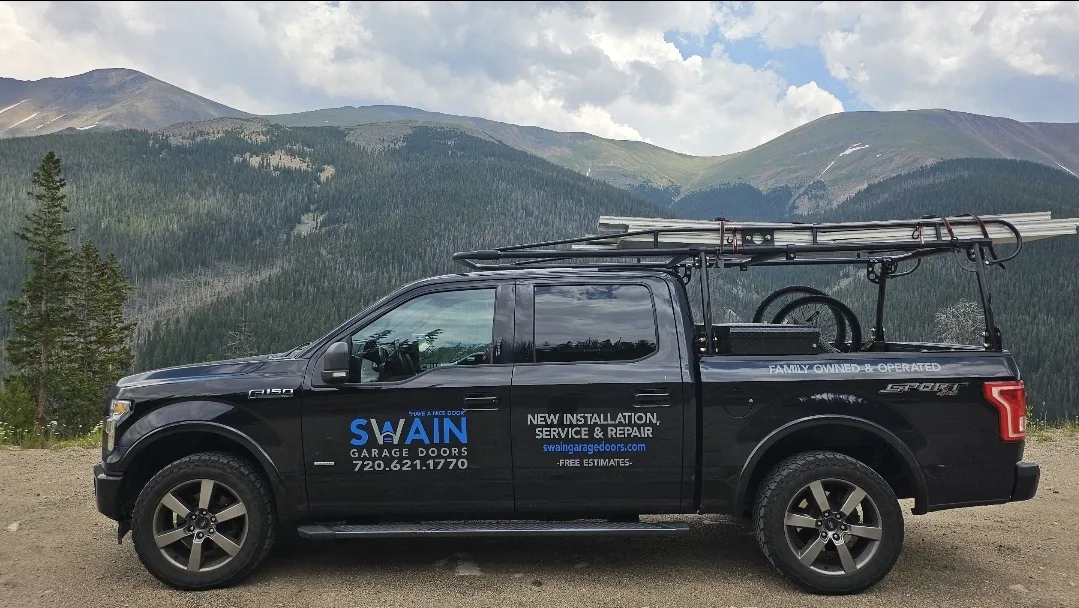 Swain Garage Doors service truck with Colorado Rocky Mountains in the background