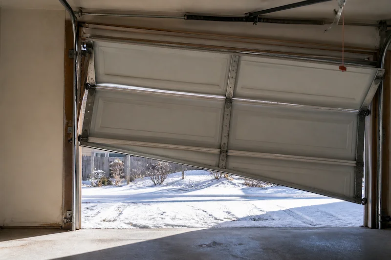 Garage door off track and misaligned inside Brighton Colorado garage